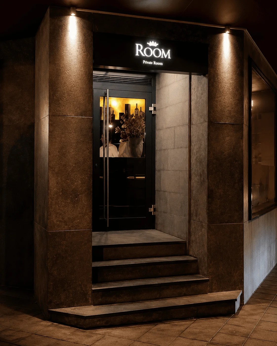Illuminated entrance of Restaurant ROOM on Olgastraße in Ulm at night
